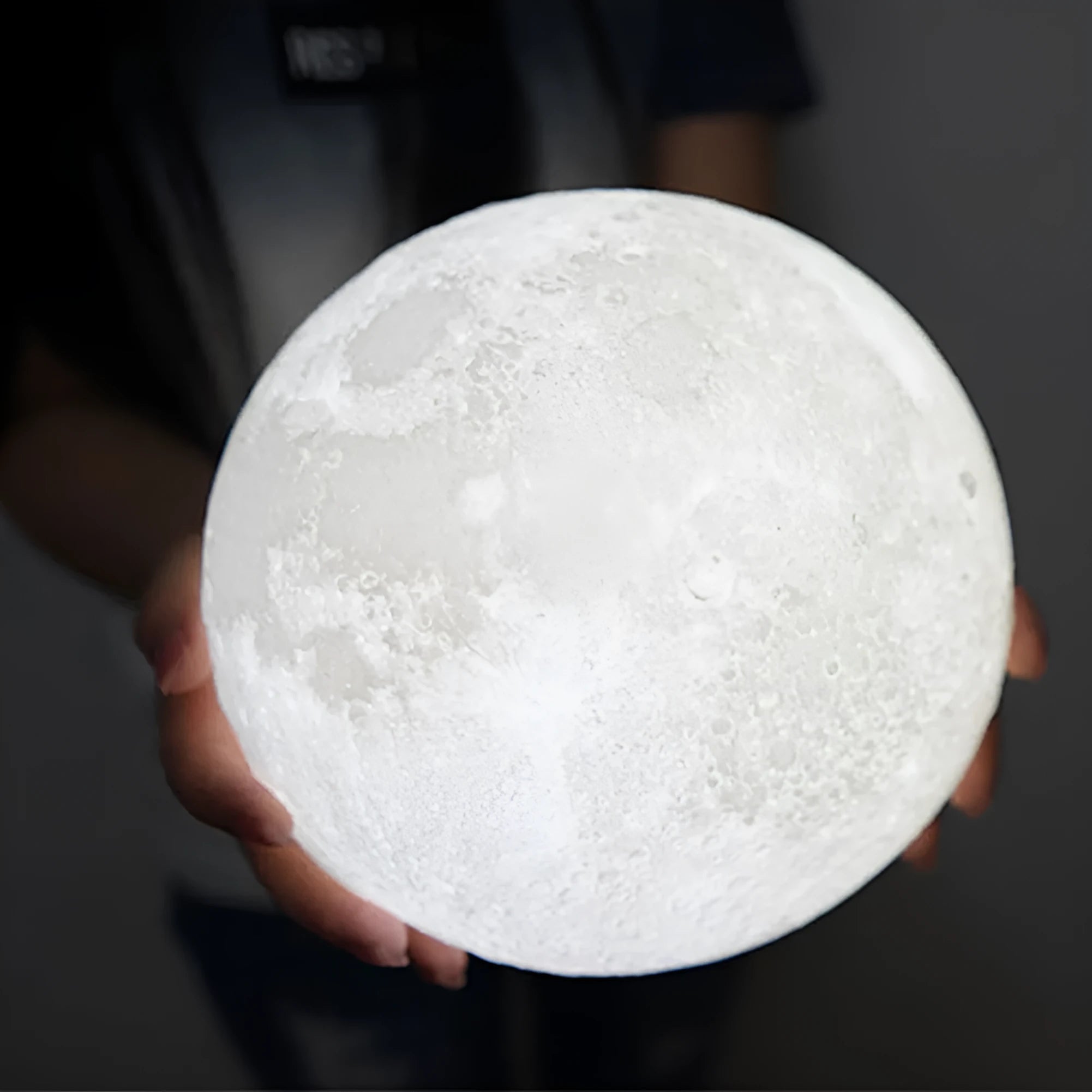 3D printed white moon lamp with detailed craters on a wooden holder, showing touch ring at base.