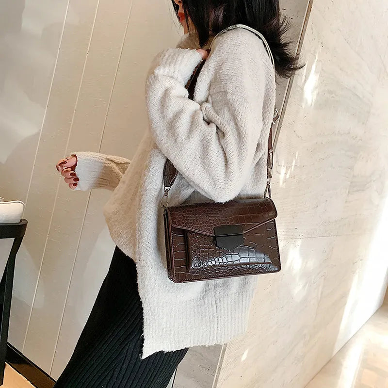 Vintage PU leather crossbody bag shown in black, dimensions 20cm by 14cm.