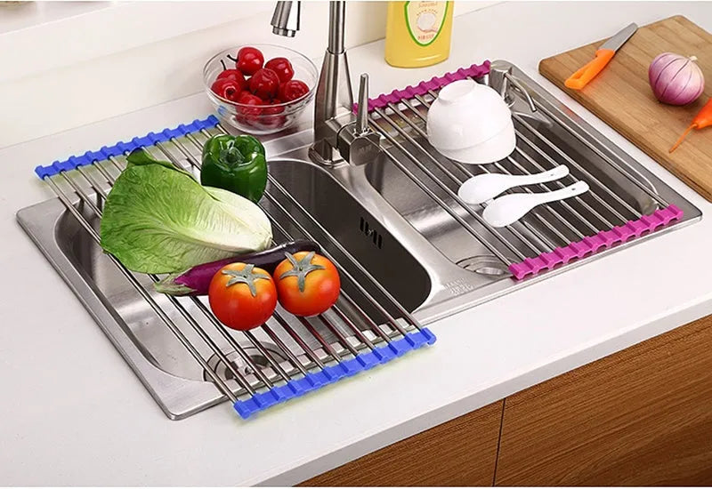 Folding stainless steel and plastic kitchen sink drain rack in blue, shown extended for use and collapsed for storage.