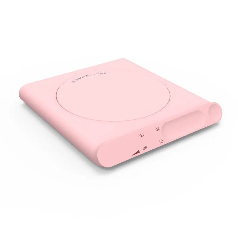 Pink and white USB-powered heating cup pad with mechanical timer control for keeping mugs warm.