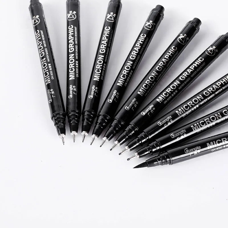 Set of black comic drawing pens with multiple nib sizes in a storage bag organiser.