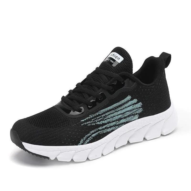 Black and white platform running sneakers with round toe and cross strap details