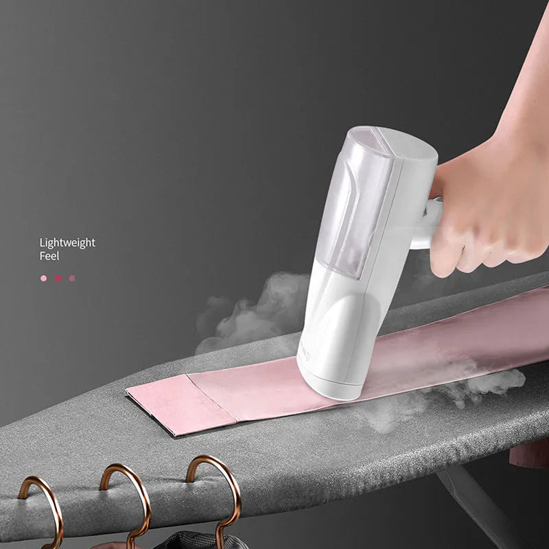 White folding ironing machine with 800W steam, measuring 10x6.2x18cm folded, on a plain background