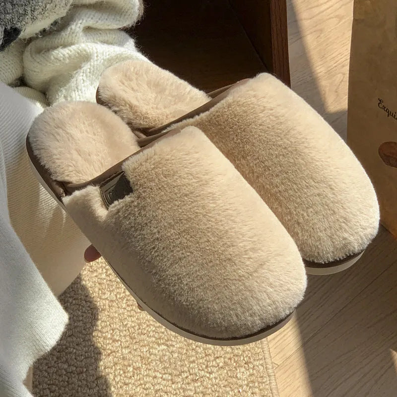 Pair of solid-colour plush winter slippers with a PVC upper and textured non-slip sole.