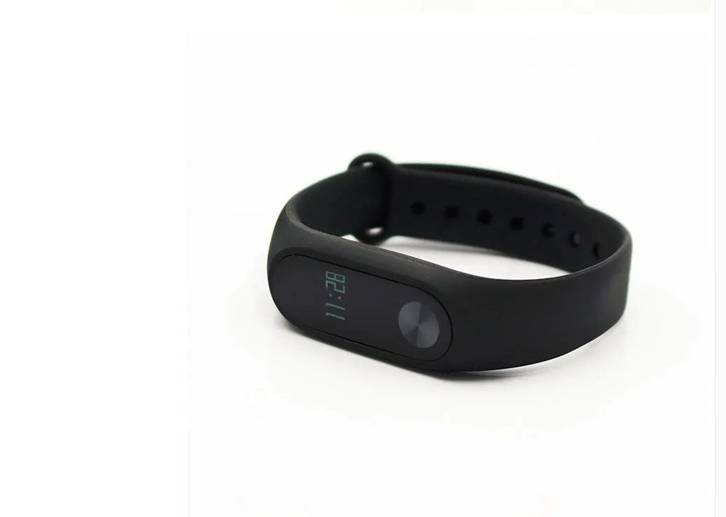 Xiaomi Mi Band 2 black fitness tracker on wrist showing OLED display with heart rate reading.