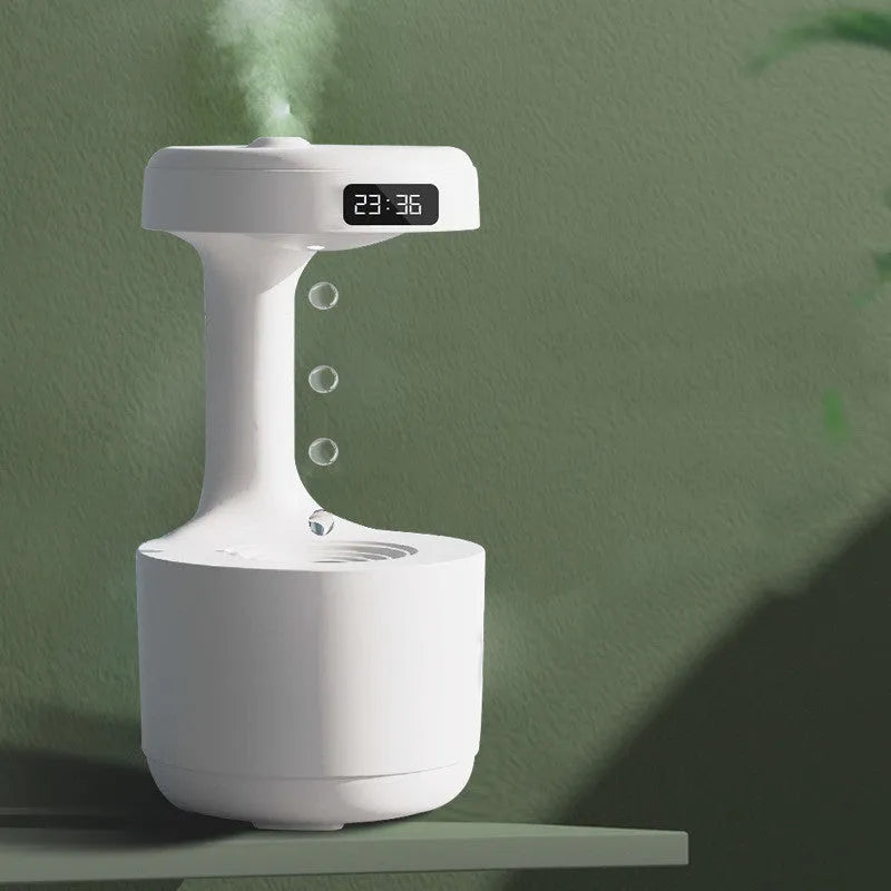 White columnar anti-gravity humidifier on a desk with LED clock display and visible mist.