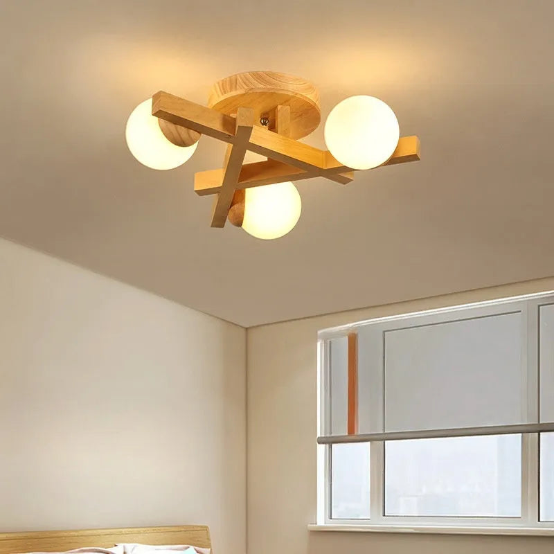 Modern Nordic-style ceiling light with wooden accents and three white lamp heads mounted on a clean, white ceiling.