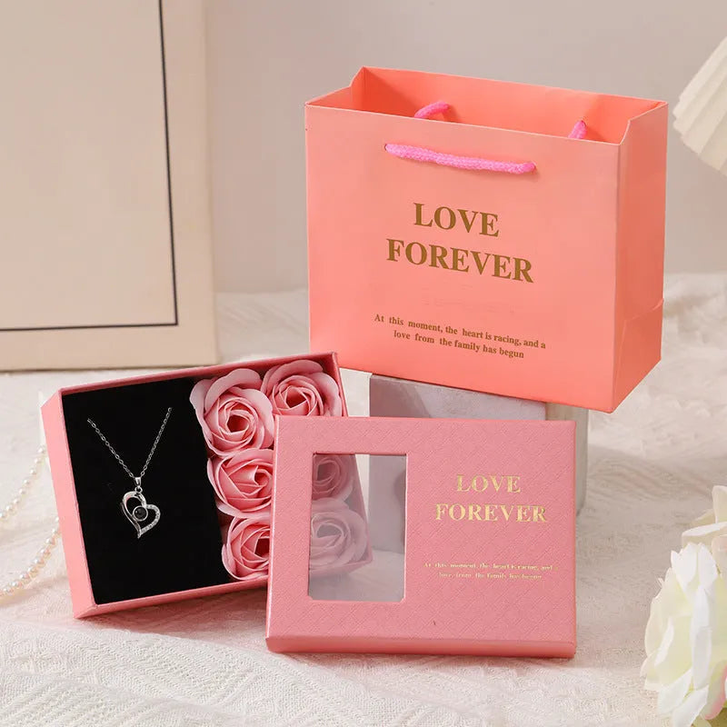 Six red soap roses in a black Korean-style gift box with a matching handbag