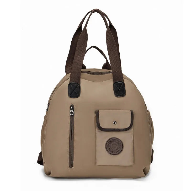 Large black nylon outdoor backpack with a front sandwich pocket, shown next to a khaki version.