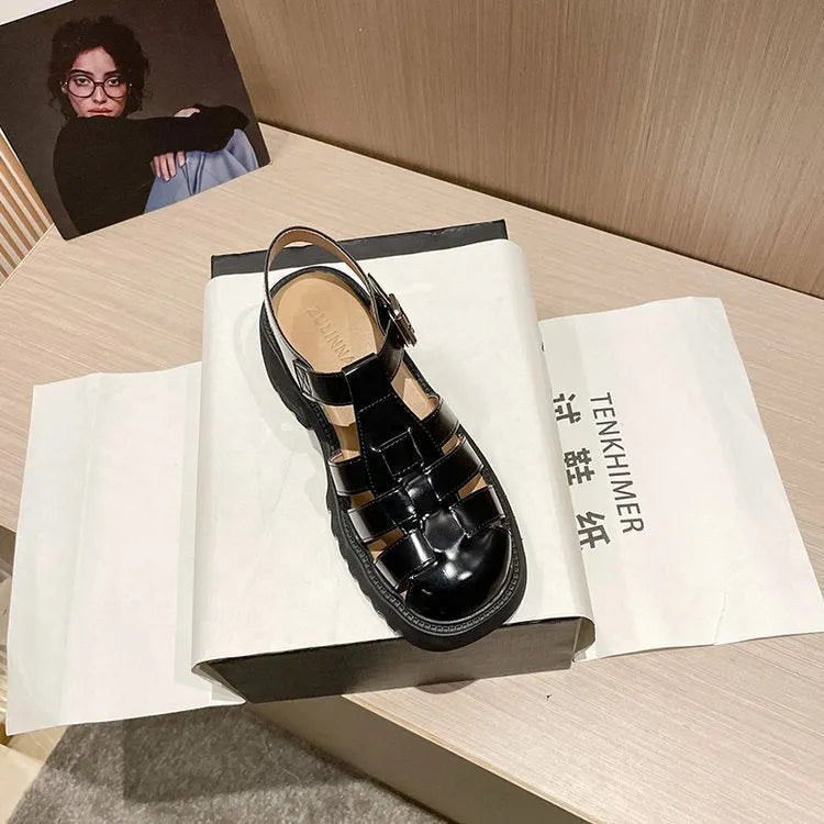Women's black retro platform sandals with a chunky heel, closed toe, and buckle fastening.