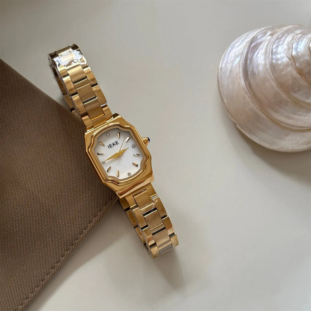 Women's small square watch with gold strap and green dial, 10mm thin, on wrist