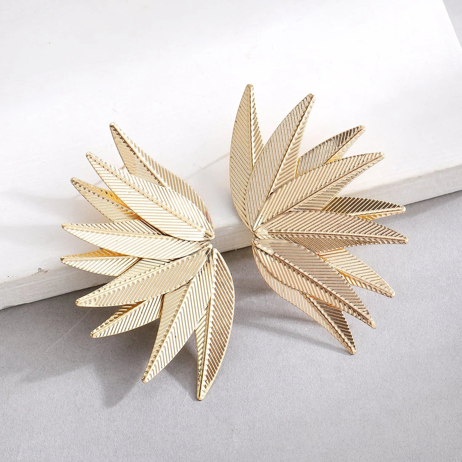 Gold and white leaves patch earrings showing detailed leaf design on alloy metal