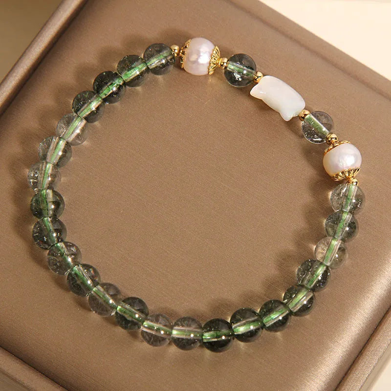 Green phantom quartz bracelet with shell kitten charm on wrist