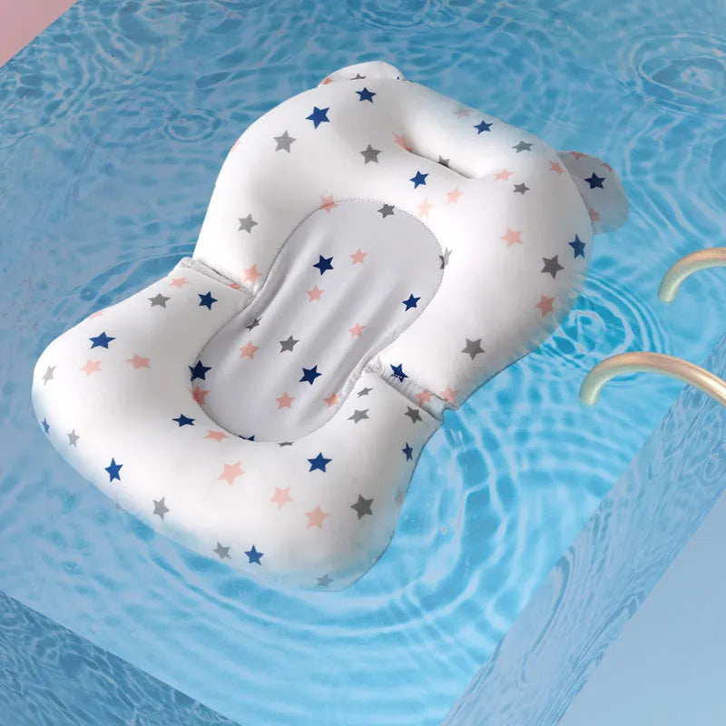 Foldable baby bath support mat with styrofoam cushion in white star pattern, placed in a bathtub