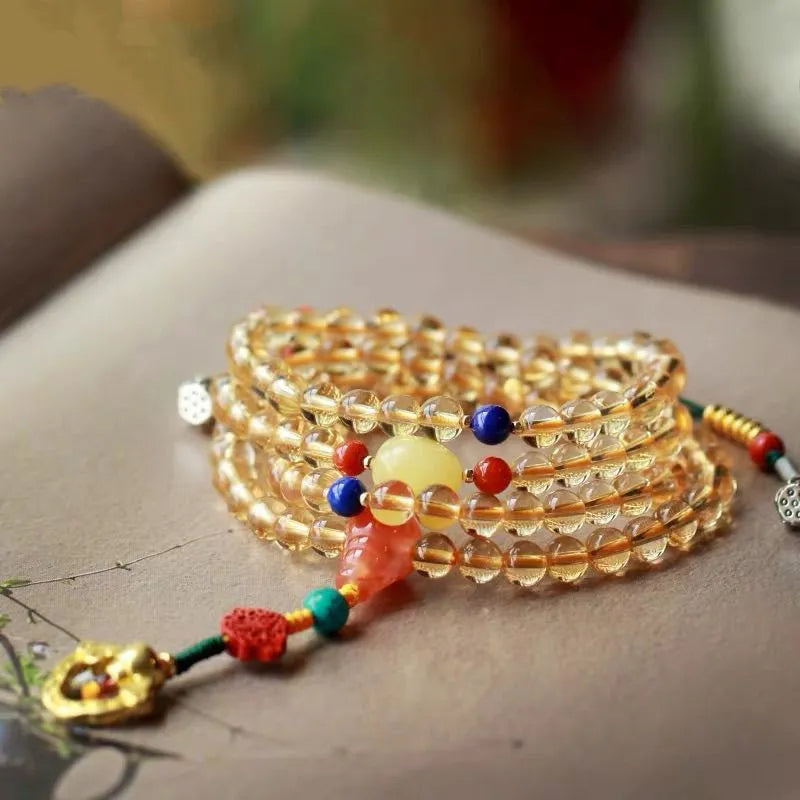 Close-up of a yellow natural citrine bracelet with 1mm beads on a filament string.