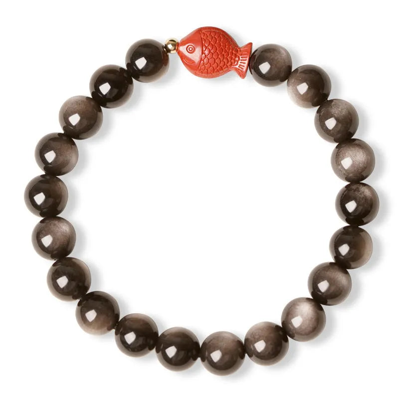Natural obsidian bracelet with round cinnabar beads in three size options on a wrist