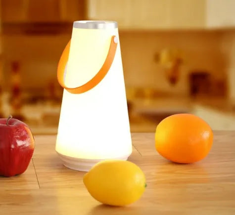 White rechargeable LED night light with touch controls measuring 12x12x22cm