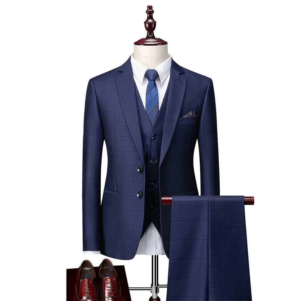 Men's navy blue slim fit three-piece suit with jacket, vest, and trousers on hanger