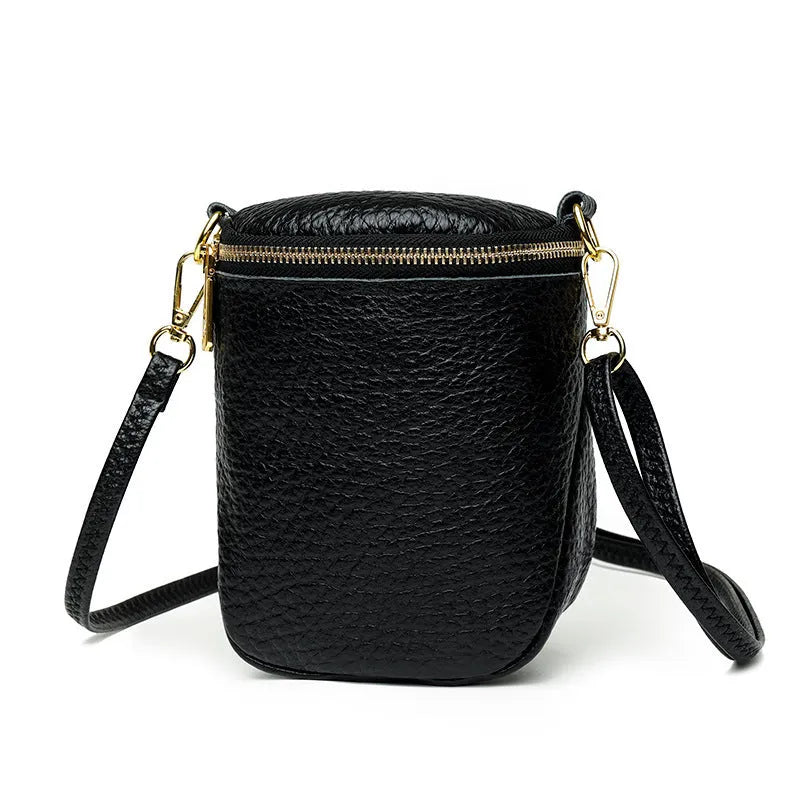 Genuine leather small crossbody bag in black with adjustable strap and shell shape design