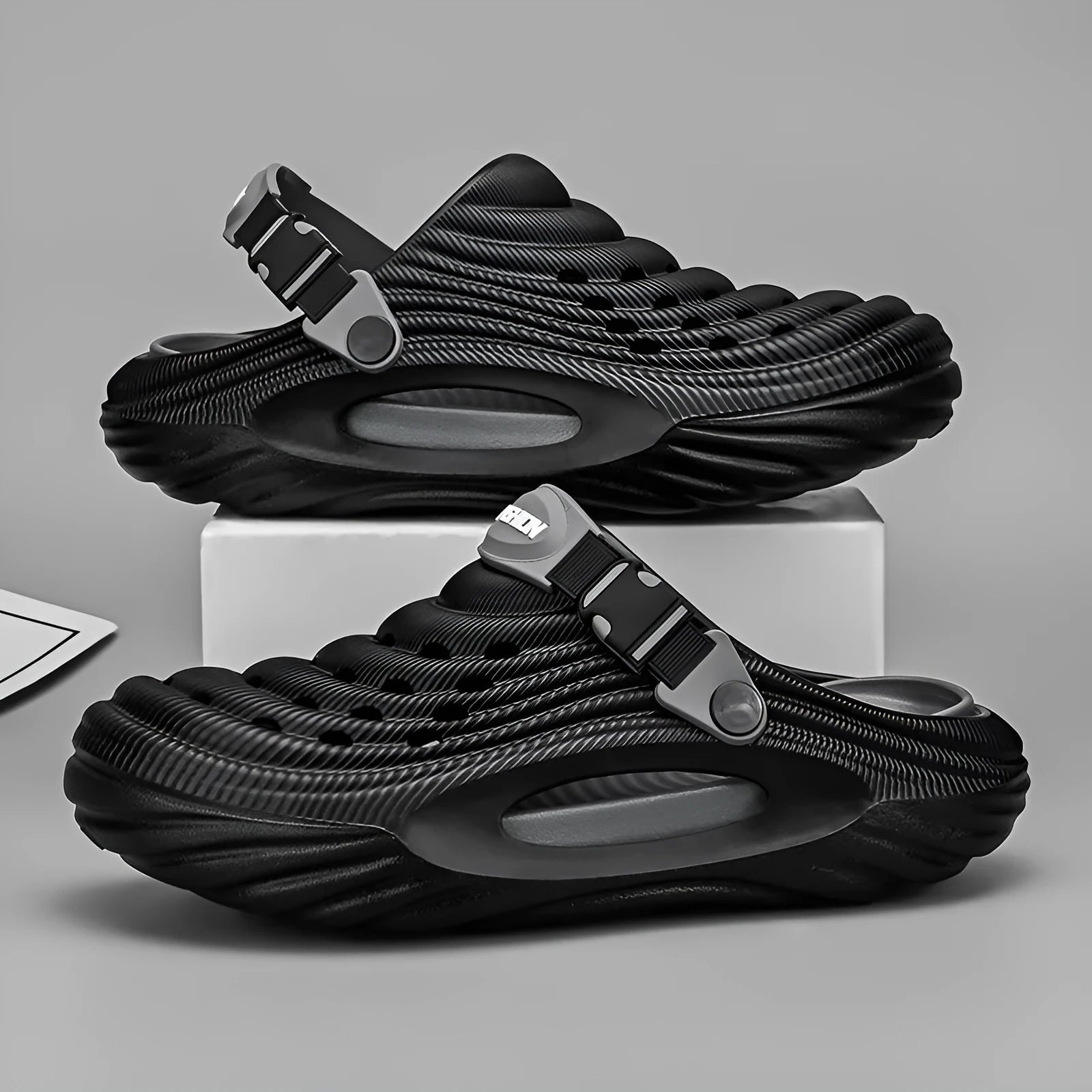 Men's solid colour EVA platform slippers with hollow-out design in black, shown from the side.