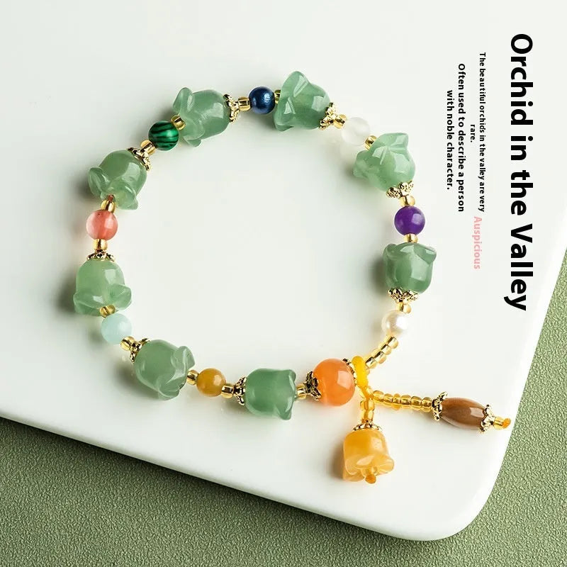 Natural Xinjiang Jinsi Jade bracelet with carved orchid beads in aventurine orchid colour.