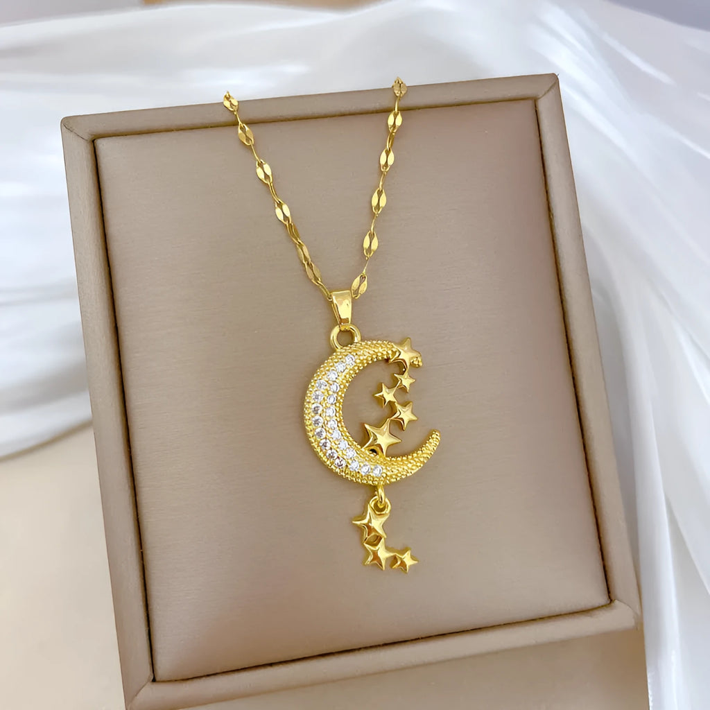 Geometric openwork moon pendant necklace with a linear crystal tassel on a silver stainless steel chain.