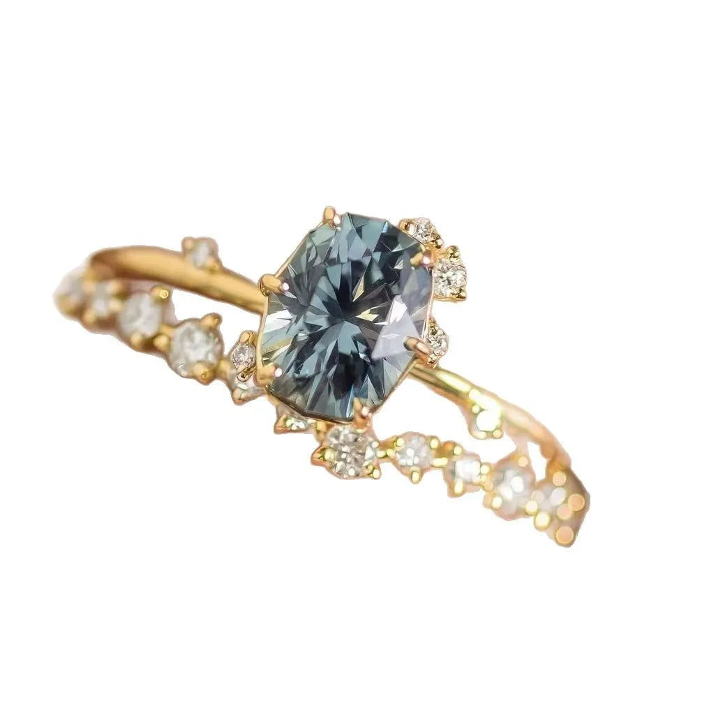 Women's gold floral ring with a green zircon stone, shown as a pair.