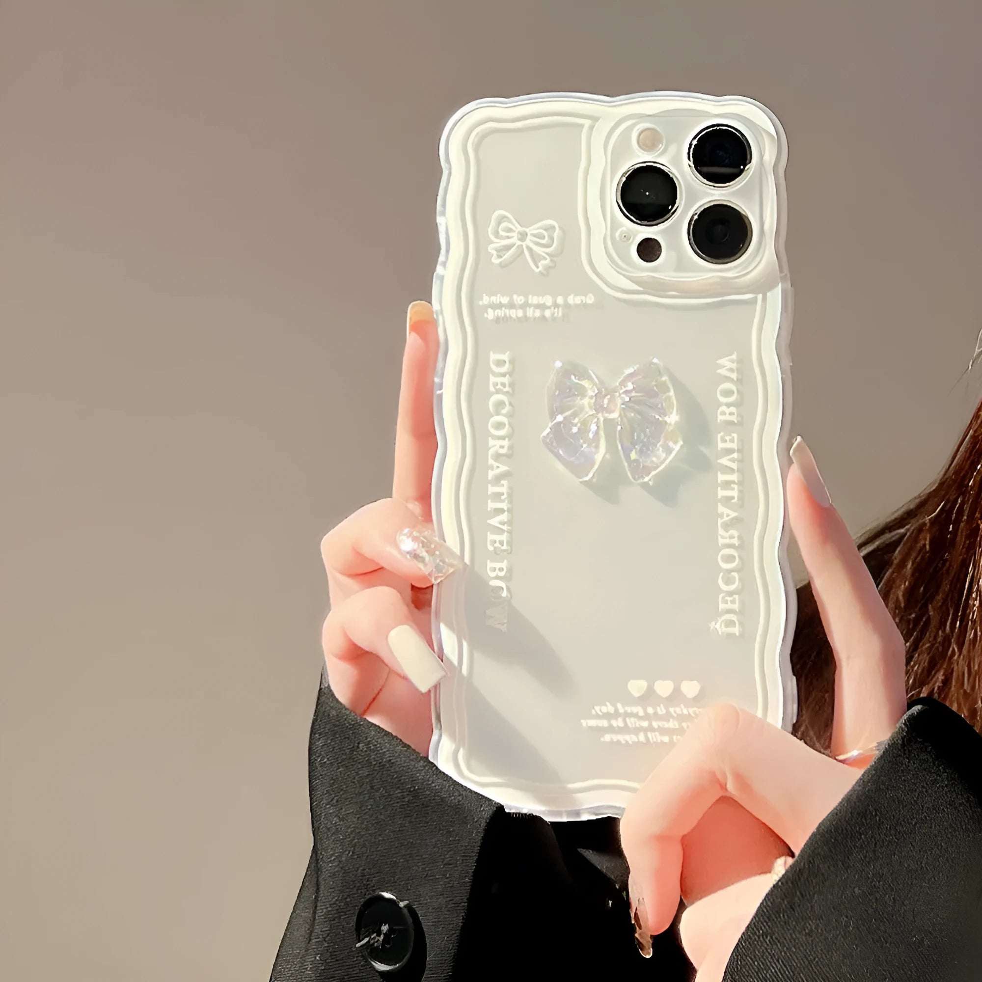 Transparent iPhone case with a raised 3D ice-through bow decoration on the back.