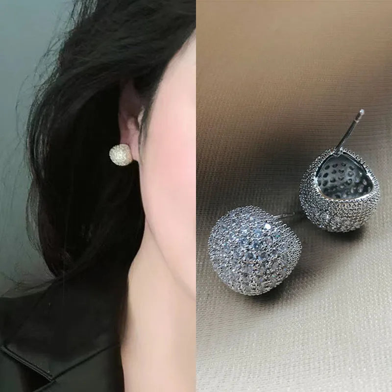 Women's drop-shaped clip earrings with full diamond elements and golden beans detailing