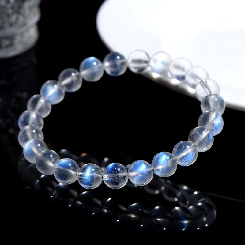 Blue Moonlight quartz bracelet with natural cream body beads on a white background.
