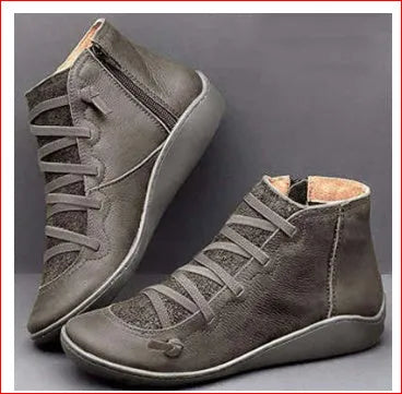 Women's casual ankle boot with wedge heel and round toe in various colours including black and leopard print.