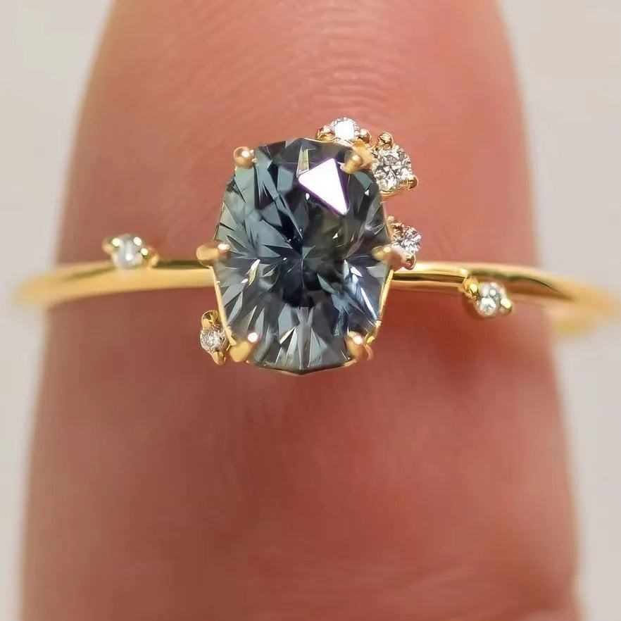 Women's gold floral ring with a green zircon stone, shown as a pair.