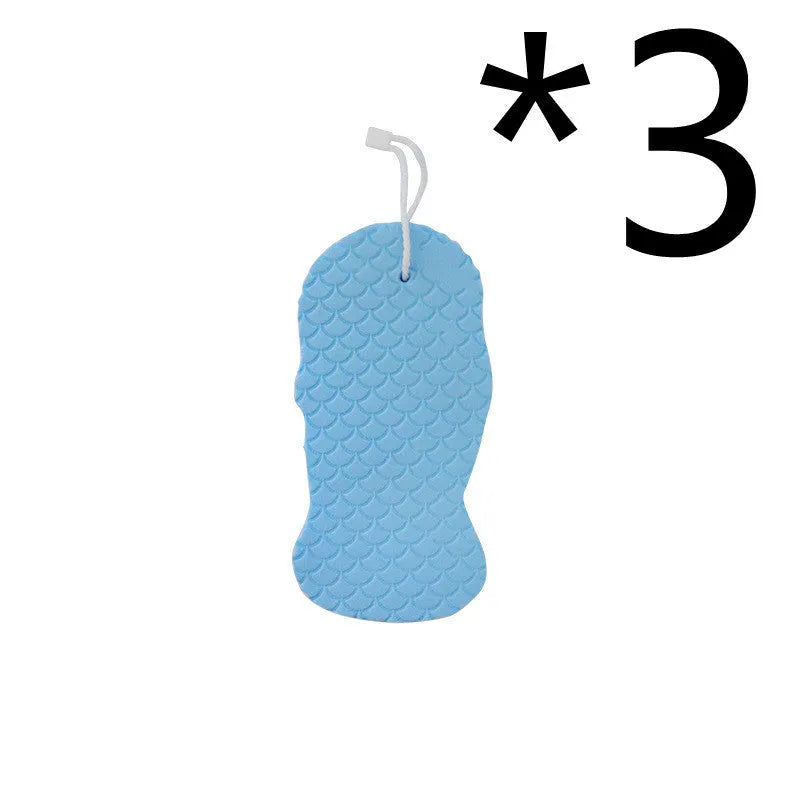 White 3D fish scale pattern bath sponge with hang loop on a bathroom background.