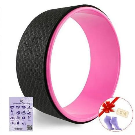 Yoga wheel in green with TPE surface and ABS core on a mat