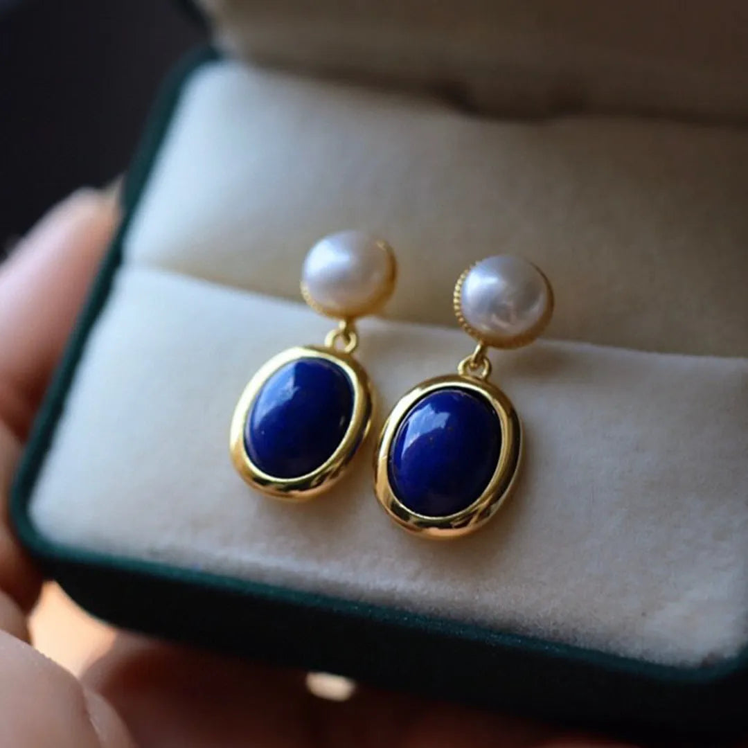 A pair of sterling silver drop earrings with a blue lapis lazuli pearl and auspicious patterns.