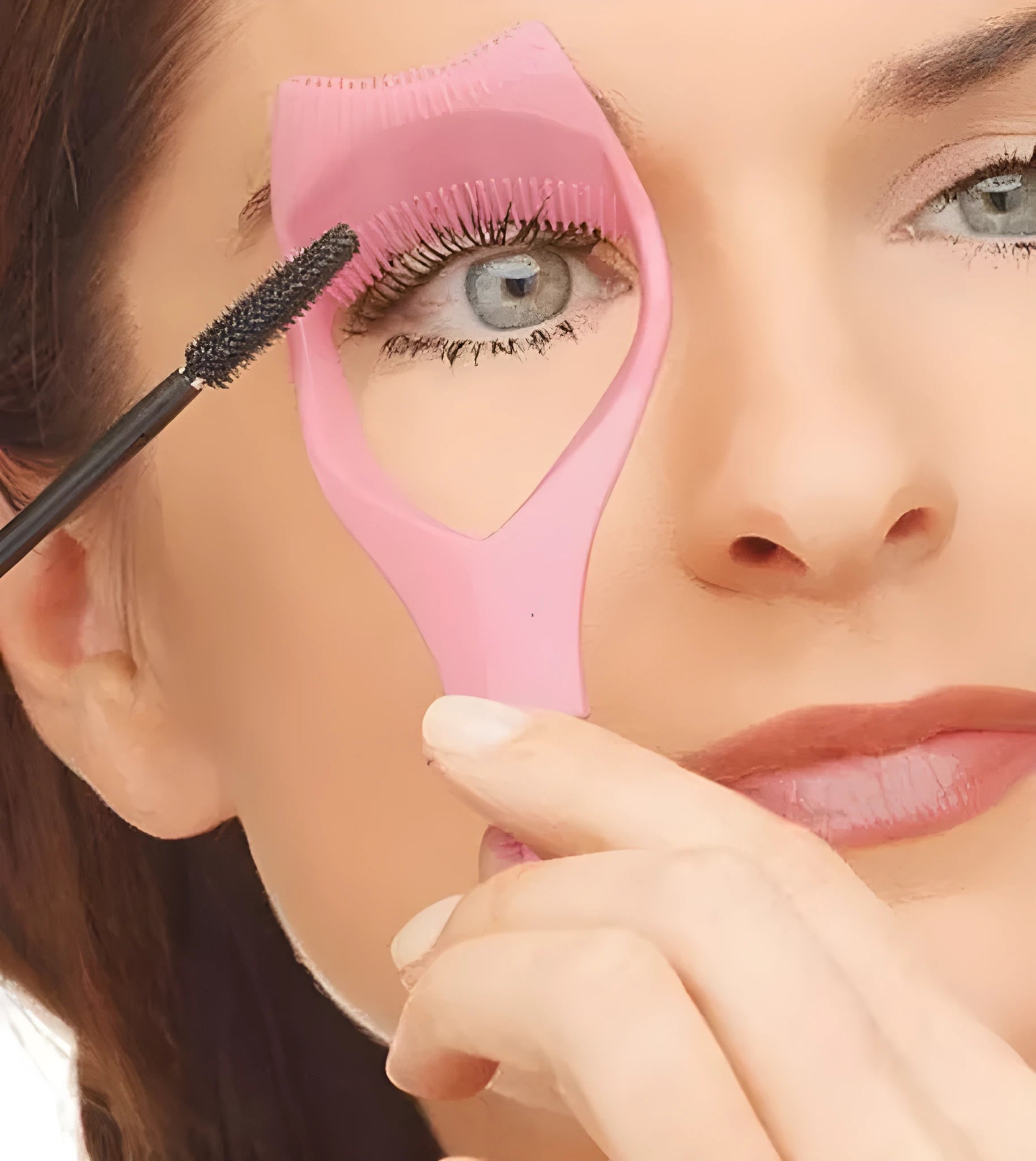 3 in 1 mascara shield guard in pink and blue made of ABS plastic sitting on a table