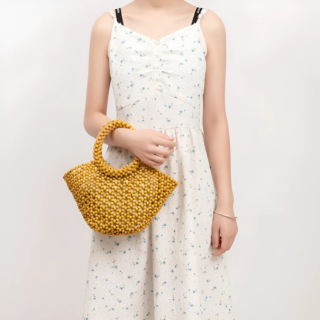Hand-woven maple wood hollow handbag with wooden bead decoration in dumpling shape