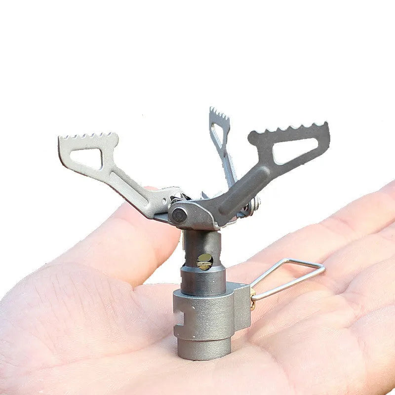 Compact silver portable camping stove with a one-piece burner, using a small green propane gas canister.