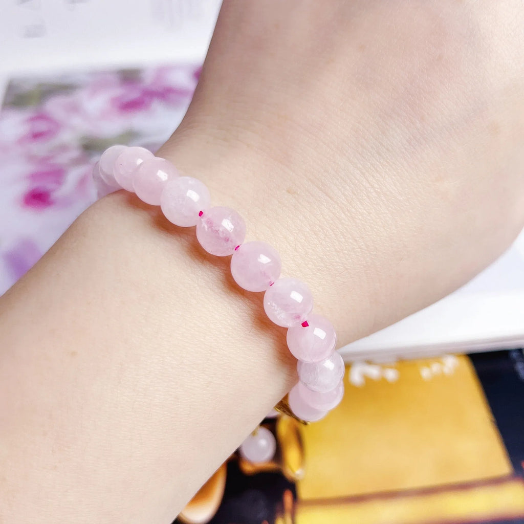 Pink crystal peach blossom bracelet with adjustable sliding knot closure on wrist