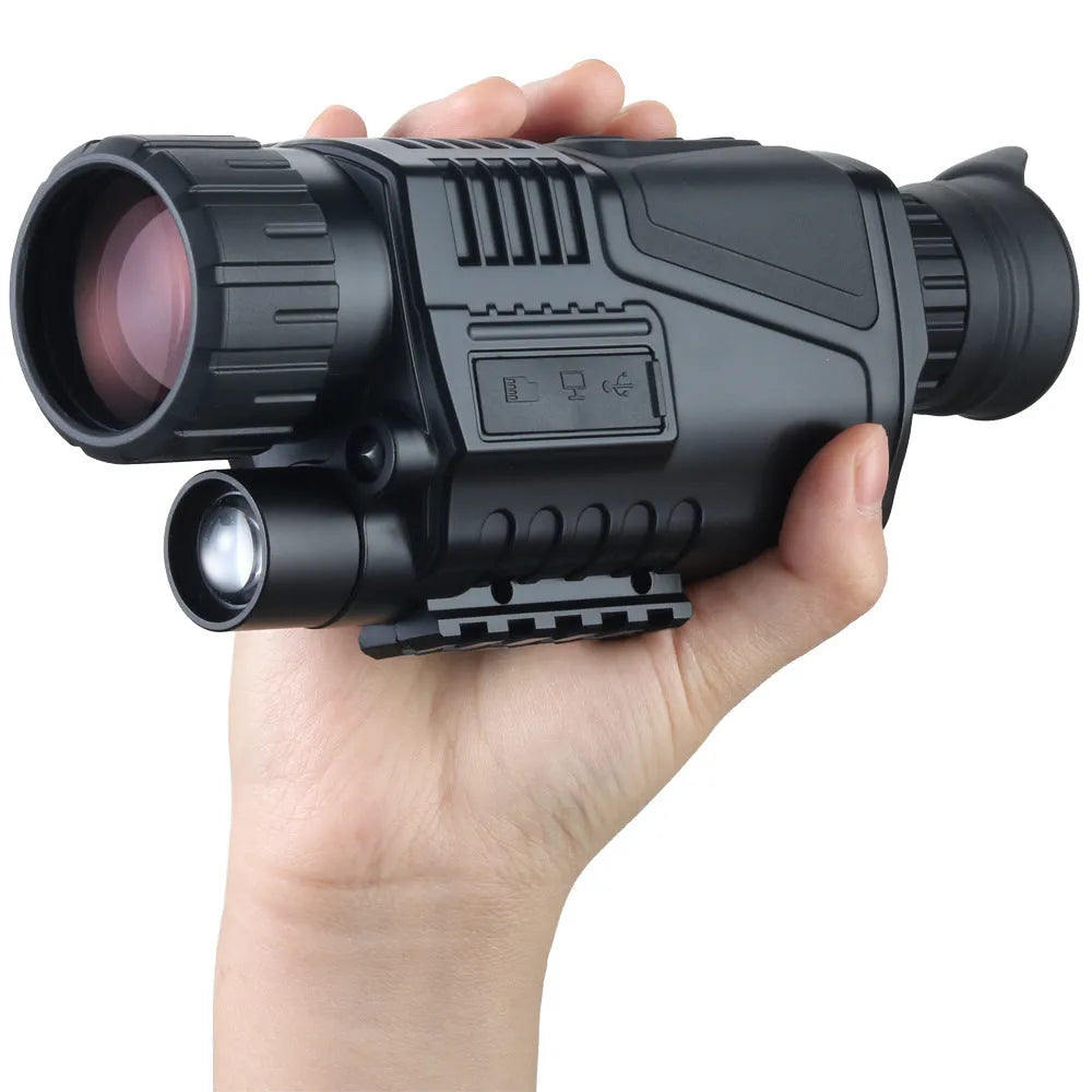Black infrared digital night vision telescope with 40mm lens, rubber coating, and storage bag on a table.