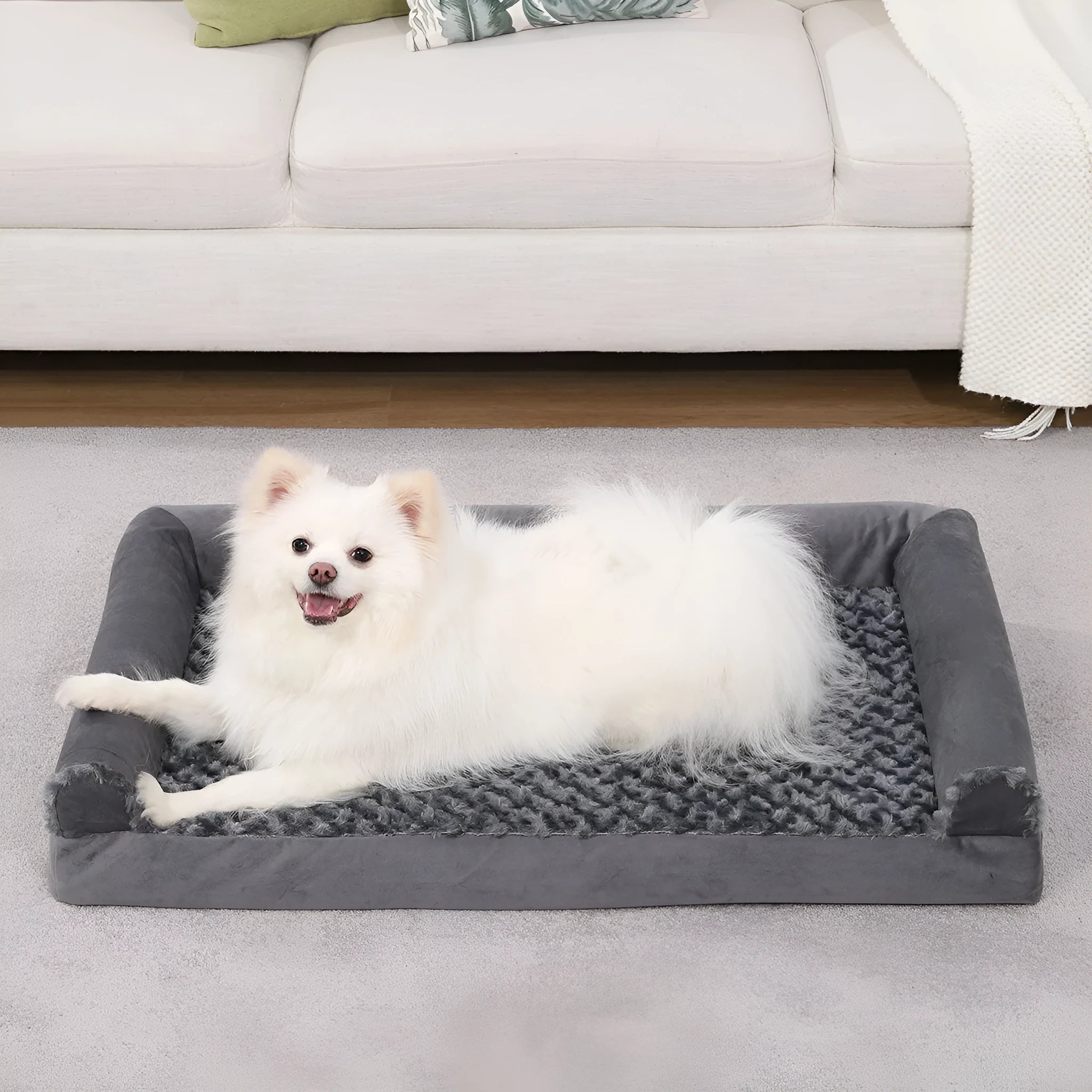 Grey U-shaped removable cover pet sofa bed for dogs on a wooden floor.