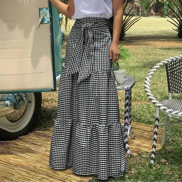 Ruffled hem strappy pleated casual loose skirt in black or blue polyester, sizes S to 3XL.