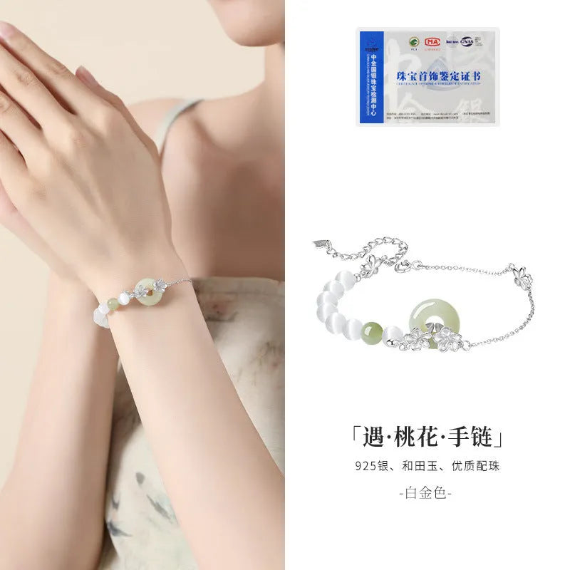 Women's pure silver safety buckle bracelet with peach blossom design in gold colour.
