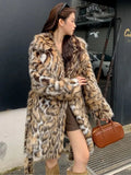 A woman's long faux fur coat with a fur collar in a street fashion style.