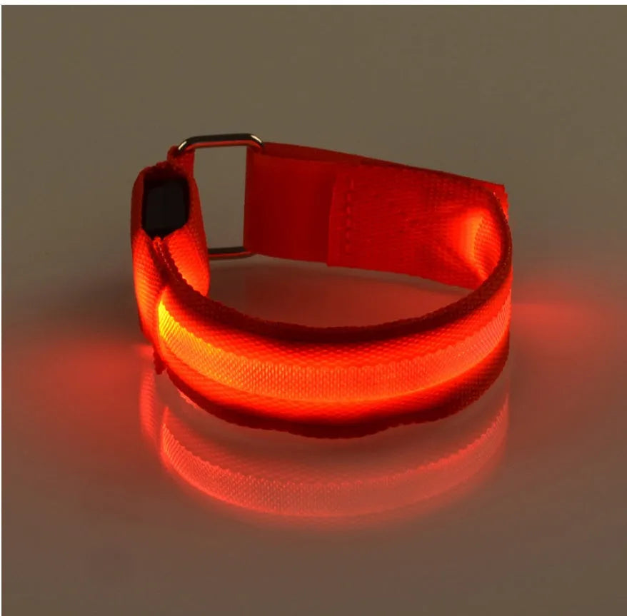 Illuminated arm band with LED lights on a black ribbon, adjustable, showing blue and red colours