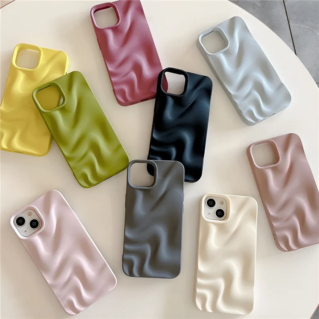 Three-dimensional pleated water ripple TPU phone case for iPhone 14 in glossy silver, showing textured back and edge coverage