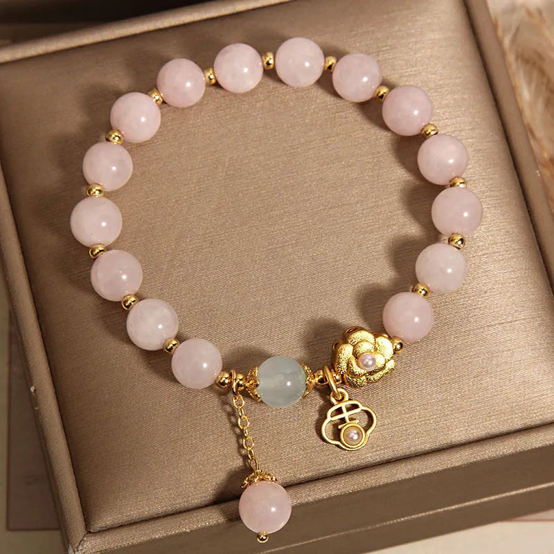 Women's pink crystal flower bracelet with a refined grace design on a wrist.
