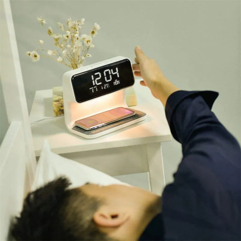 White 3-in-1 bedside lamp with wireless charging pad, LCD alarm clock display, and touch controls.