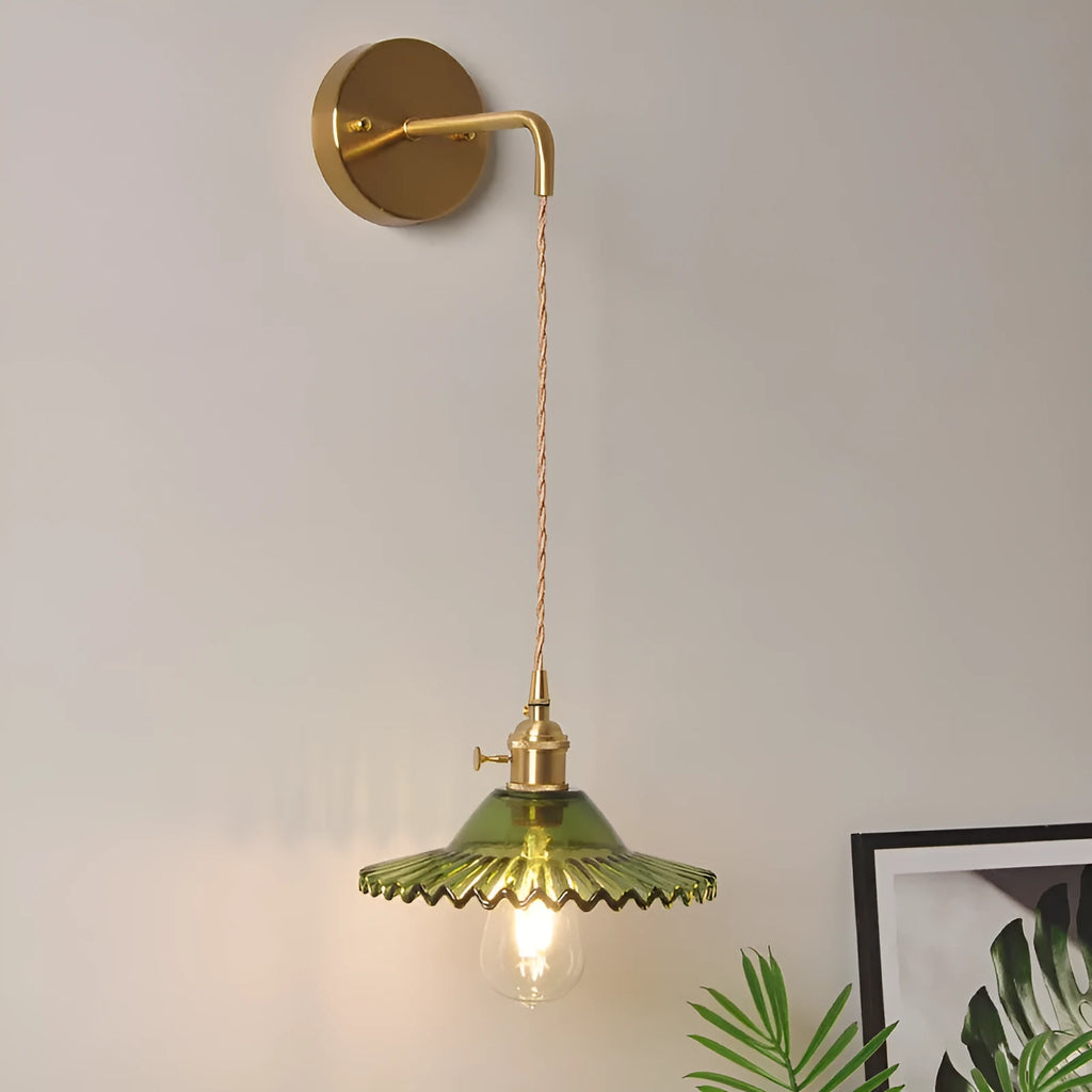 Retro brass-toned copper wall lamp with a white glass lotus shade mounted beside a bed.