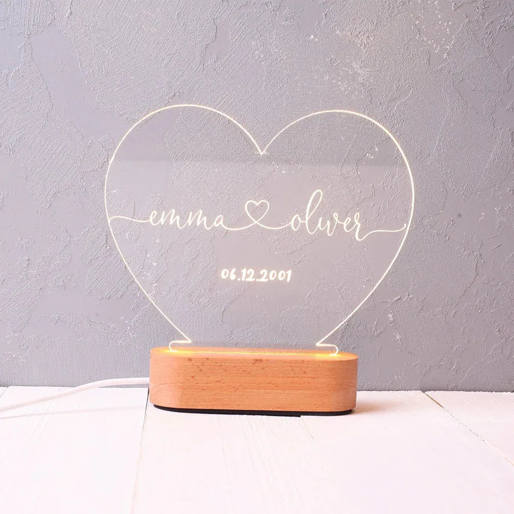 Custom transparent acrylic LED night light with personalised names and date engraving.